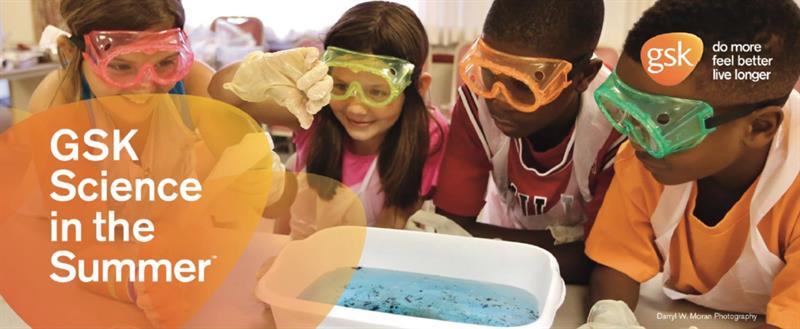 A group of multicultural kids wearing safety goggles perform an experiment.
