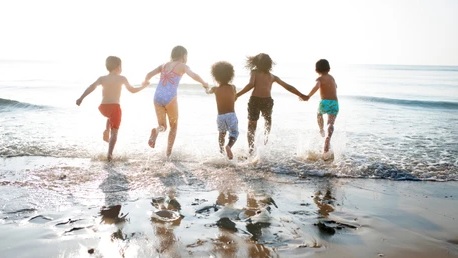 A group of multicultural children at the beach.