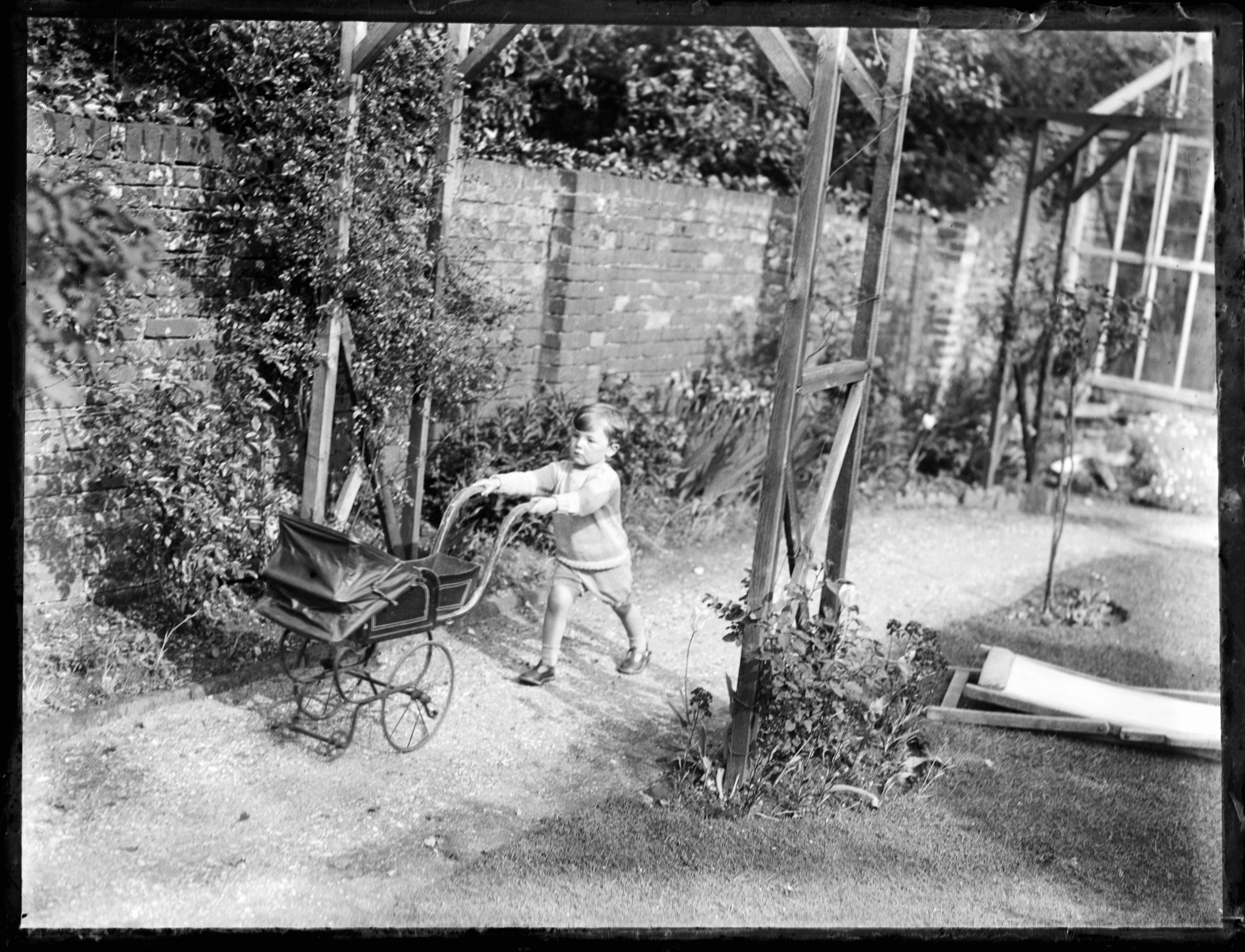 child pushing pram in 1920s