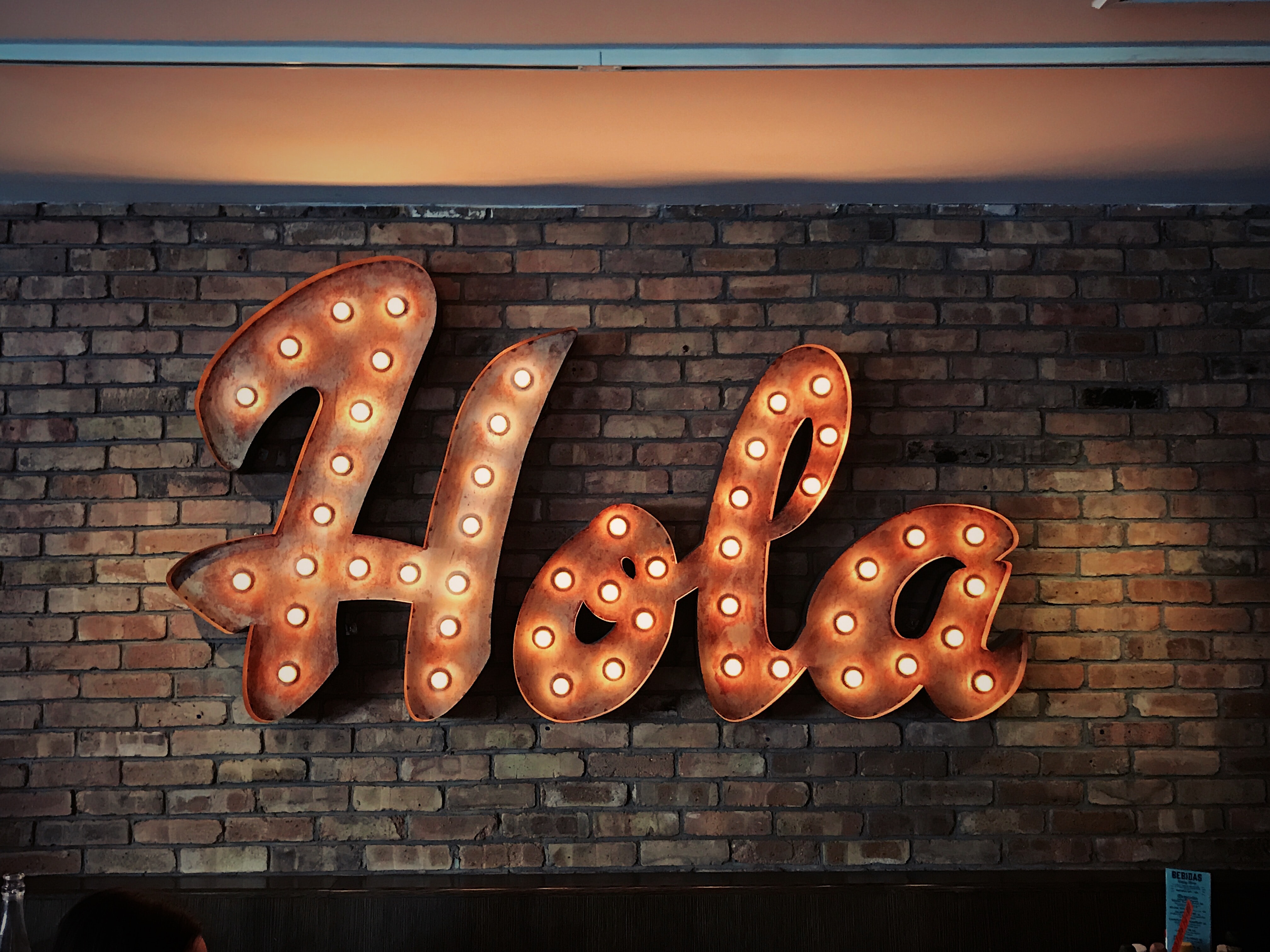 Hola in lit letters