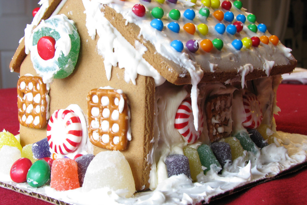 A photo of a graham cracker gingerbread house with many candy decorations.