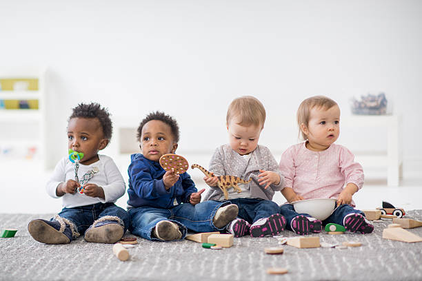 Photo of multicultural babies with toys.