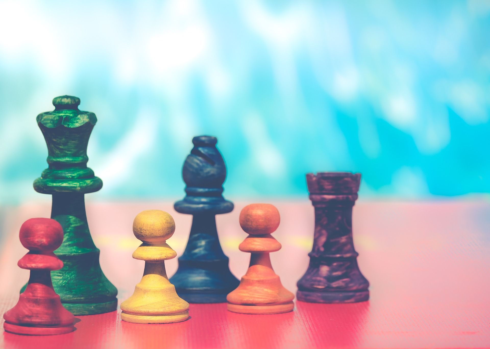 Rainbow colored chess pieces.