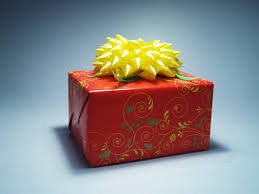 Box covered in red wrapping paper with yellow bow.