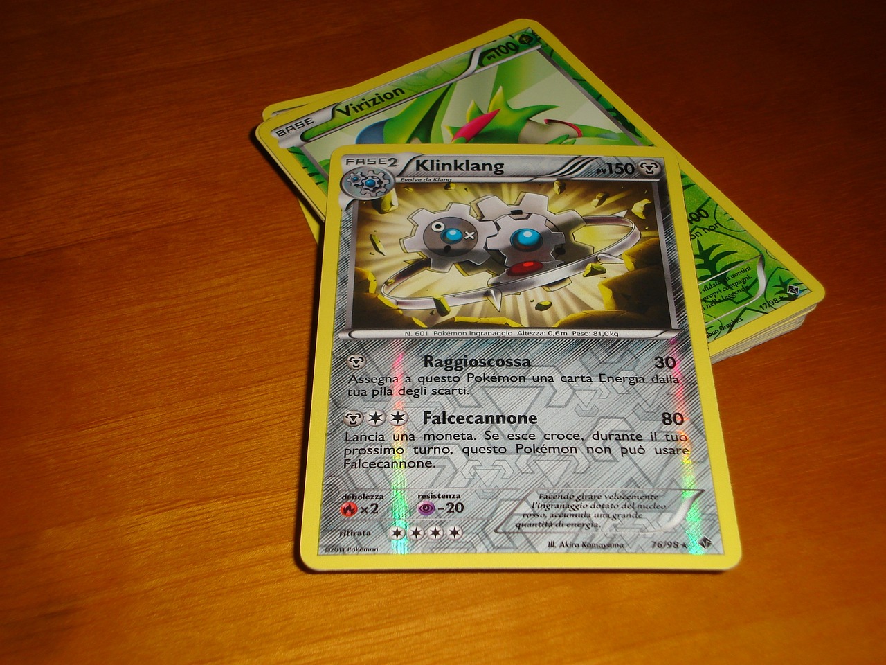 A photo of two Pokemon cards on a table.