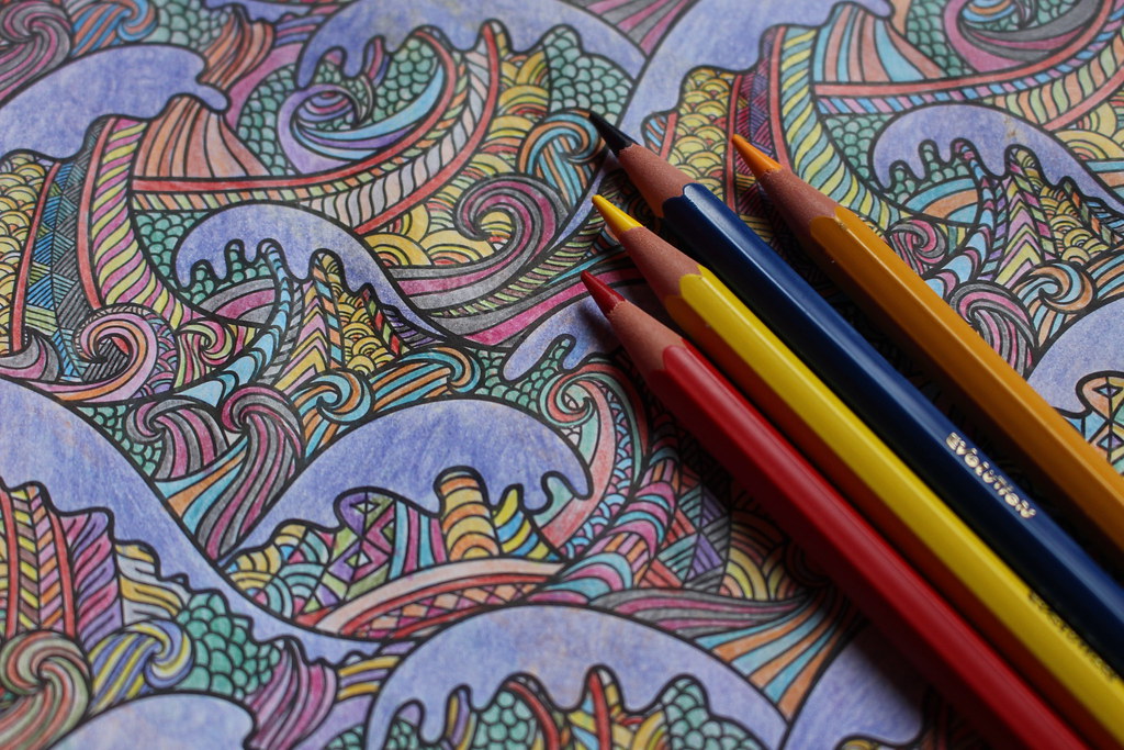 Photo of detailed coloring page and colored pencils