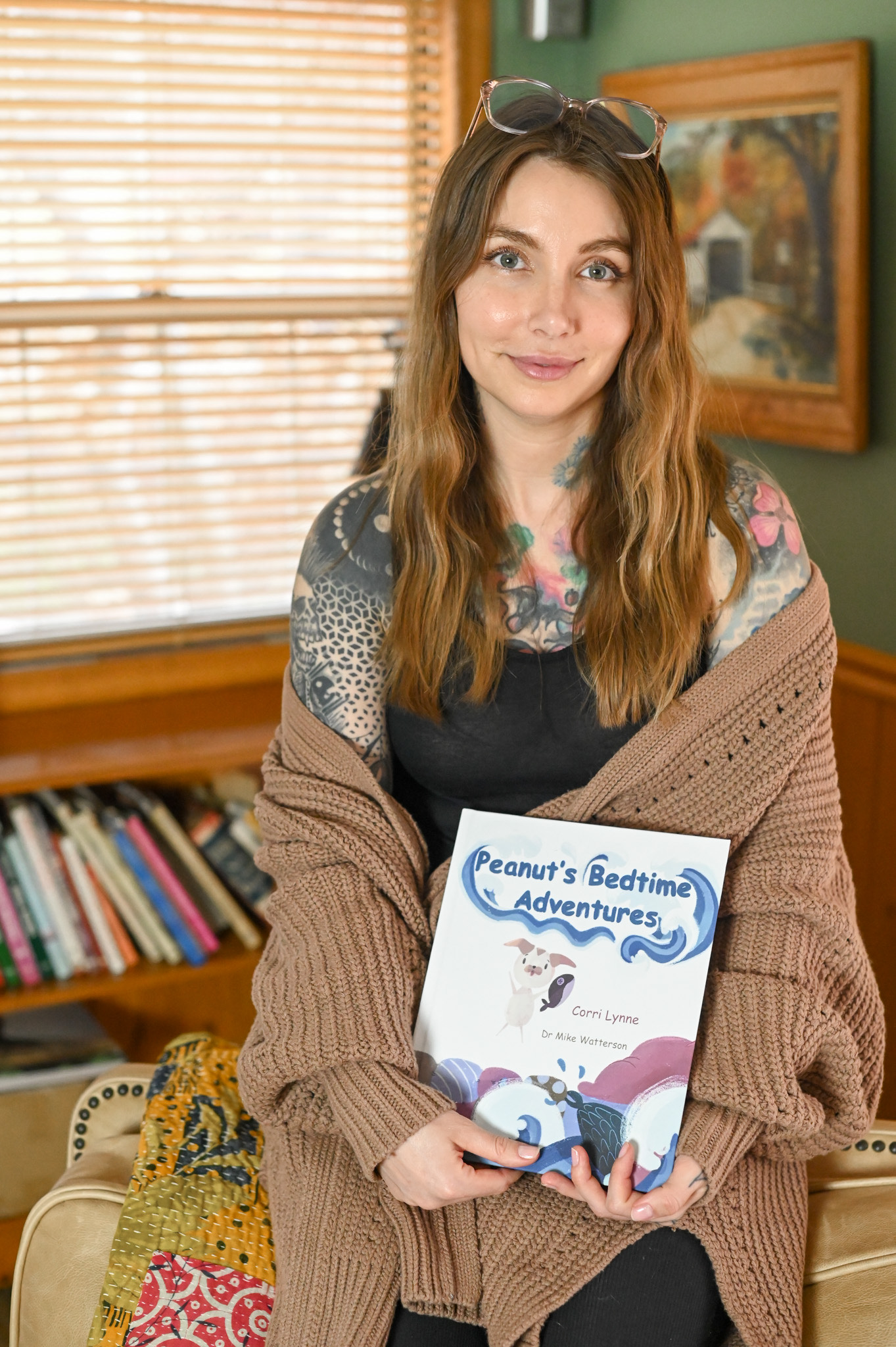 Local author, Corri Lynne, poses with her picture book, Peanut's Bedtime Adventures.