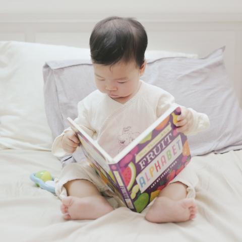 Toddler reading a book