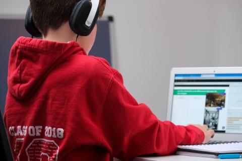 Boy with headphones using computer