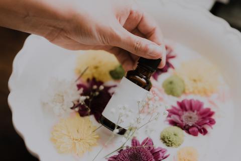 hand pouring out essential oil