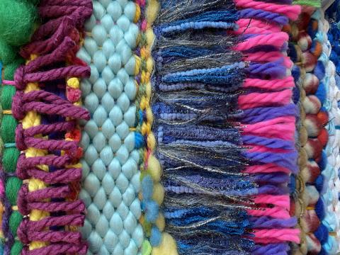 Photo of loom with various colors and textures of yarn