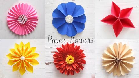 a variety of flowers made from folded paper