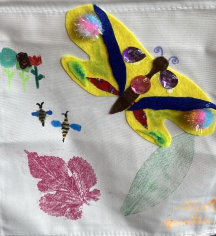 A DIY garden flag with drawings and appliqué