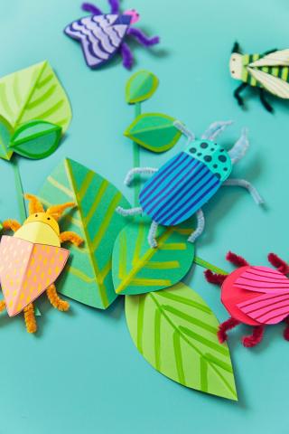 insects and leaves made out of colorful construction paper