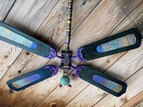 A dragonfly made out of recycled parts hangs on the Market Garden shed