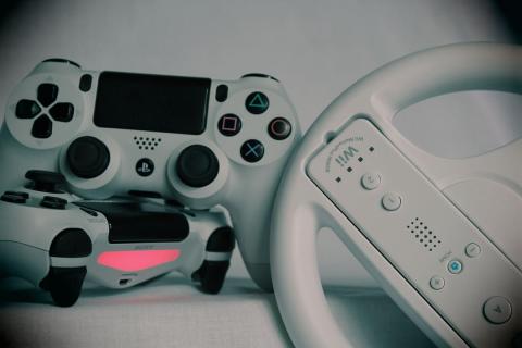 A photo of white and black gaming controllers.