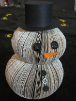 A snowman sculpture made of book pages