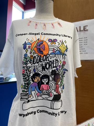Photo of Color Our World shirt decorated with fabric markers and with shapes cut out of collar