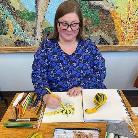 Photo of artist Suzanne Werder drawing a squash
