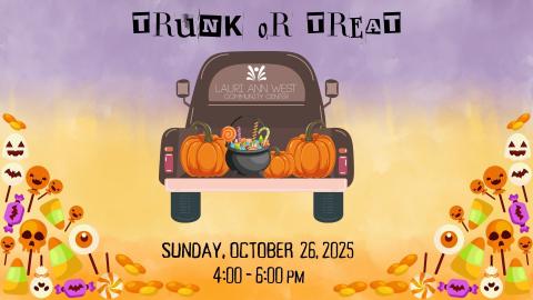 Truck trunk filled with pumpkins, candy, and a cauldron with Halloween decorations