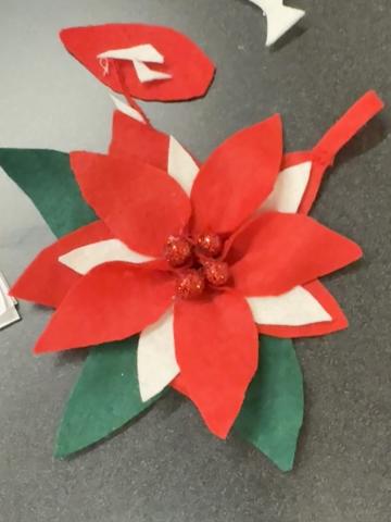 A poinsettia flower created from white and red felt.