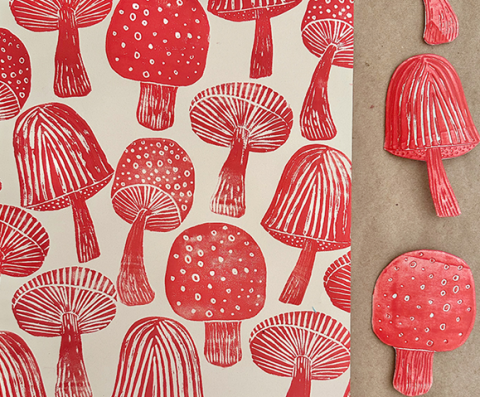 Photo of red mushroom print made with mushroom cutouts