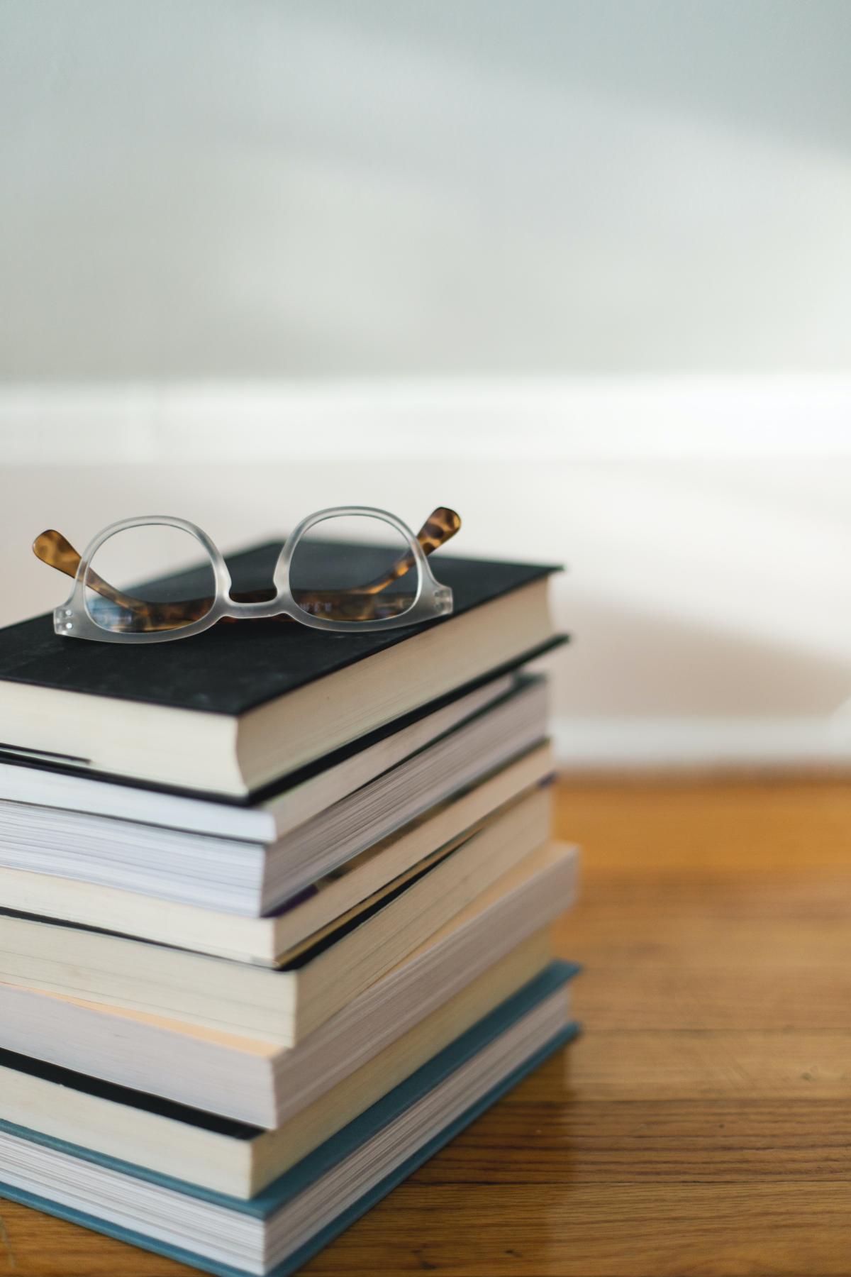 Stack of books with reading glasses