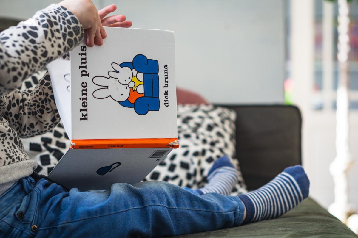 Toddler reading a book