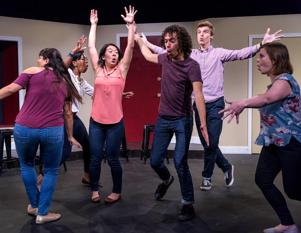 Multicultural teens perform improv.