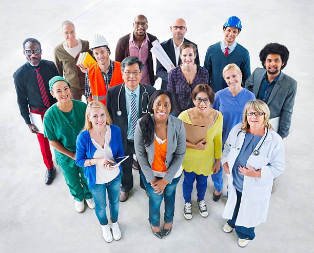 Photo of a multicultural group of people wearing clothes/uniforms from different occupations.