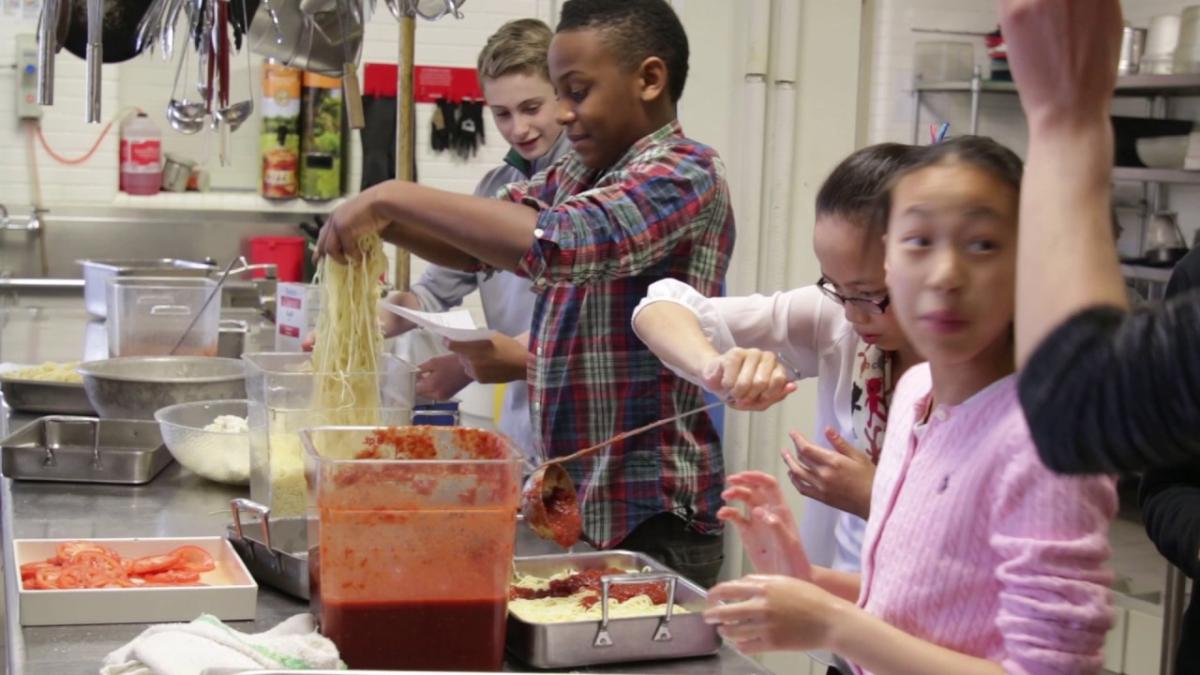 Multicultural teens cooking.