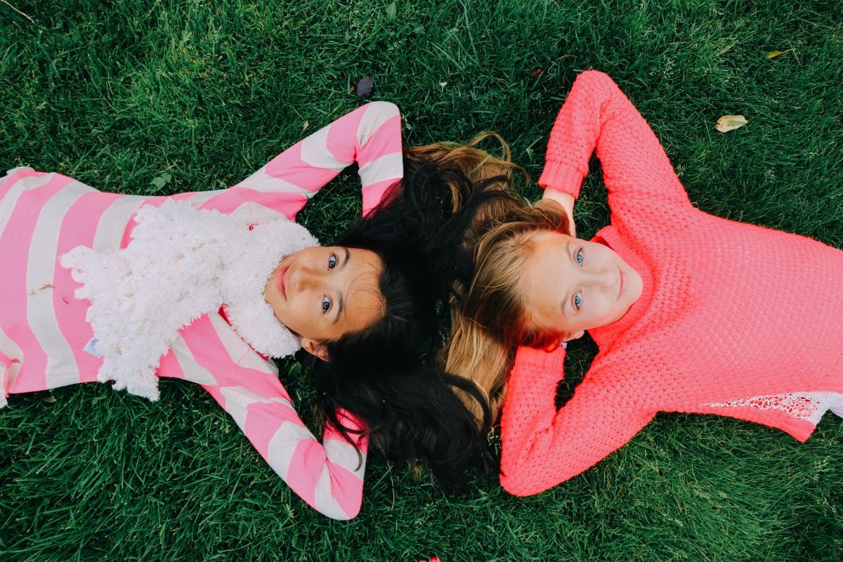 Two friends relaxing in the grass together.