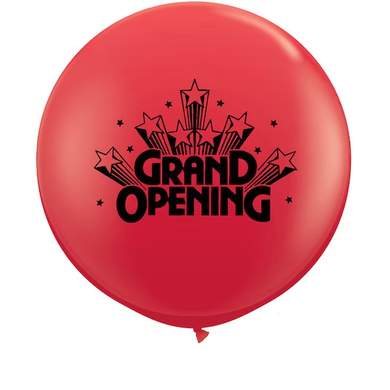 Red balloon with star bursts and text reading Grand Opening