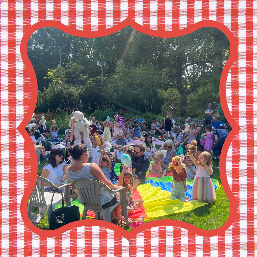 Kids hold up their teddy bears and other stuffed animal friends during last year's Teddy Bear Picnic.