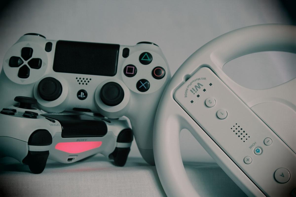 A photo of 3 game controllers together.