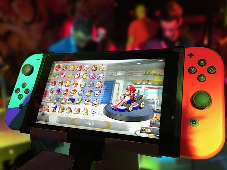 Photo of a Nintendo Switch with Mario Kart on screen