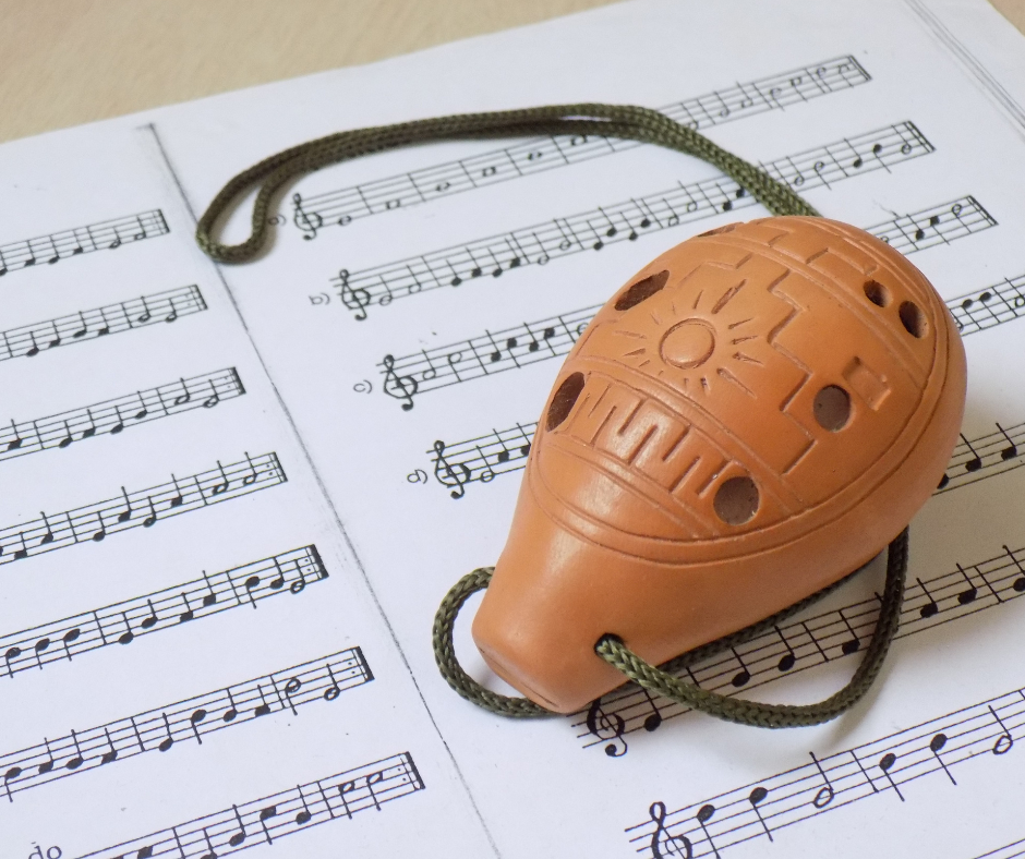 A photo of an ocarina on sheet music.